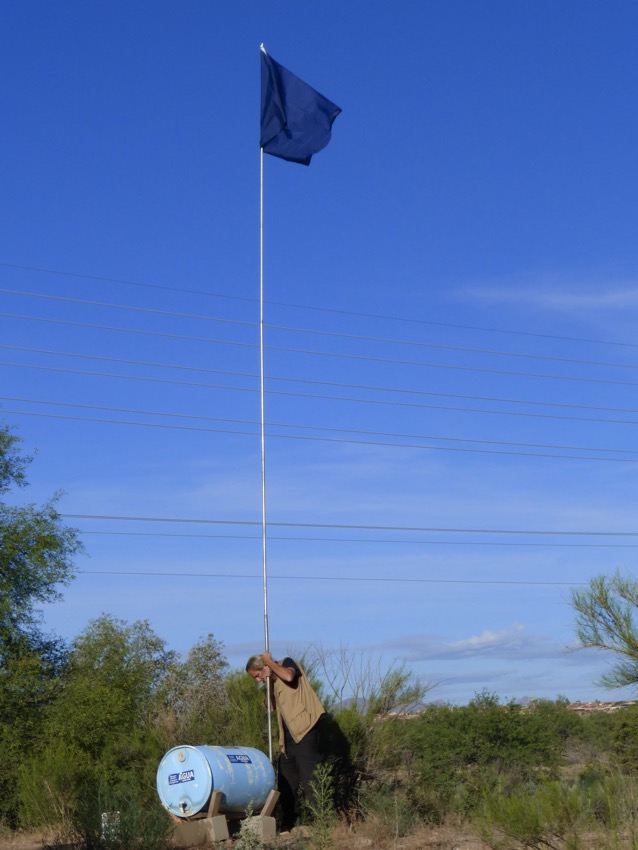 Joel Smith sets up a flag 30 feet high so immigrants walking through the desert can see its location